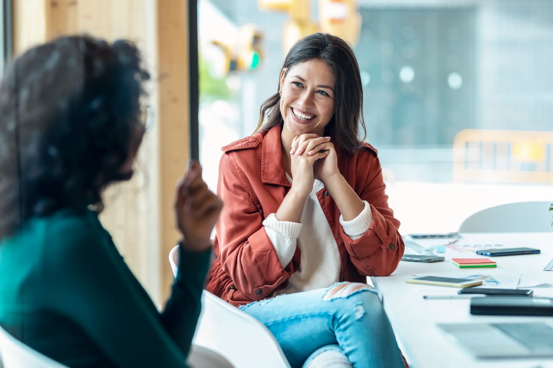two women talking to each other.
